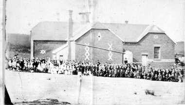 Pupils outside a school.