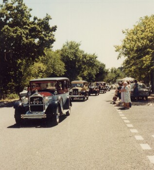 Vintage cars in a parade.