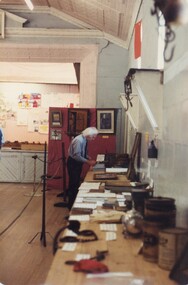 Man setting up a display.