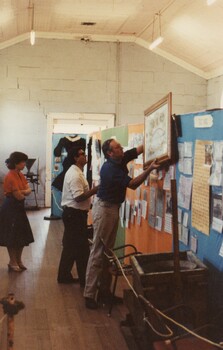 People setting up an exhibition display.