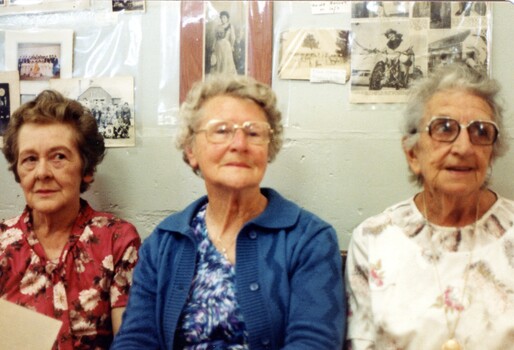 Three women at an exhibition.