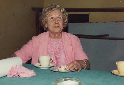 Woman having afternoon tea at an exhibition.