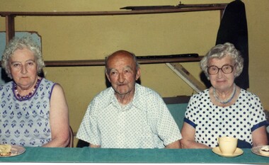 Three people at an exhibition.