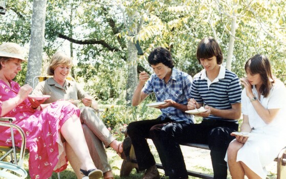 People having afternoon tea at an exhibition.