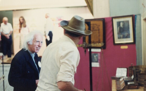 Two men at an exhibition.