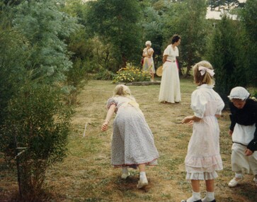 Children tossing horseshoes.