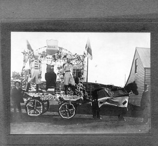 Photograph, Decorated horse-drawn float in parade, undated