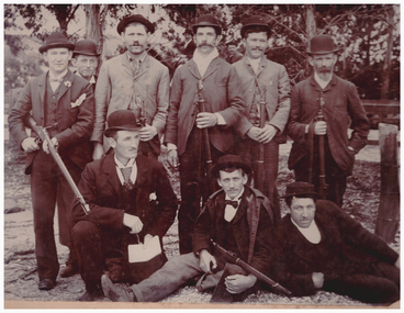 Group of men with weapons.