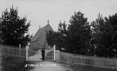 Man at gates of church.