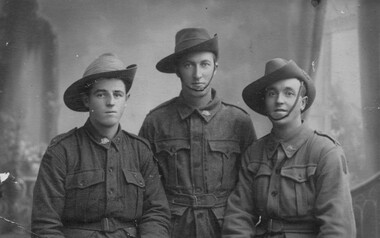 Portrait of three men in uniform.