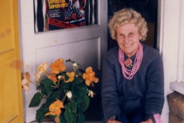 Photograph, Carrie Murrell outside Murrell's Newsagency, Linton