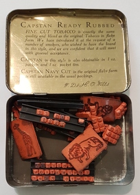 Tin with rubber stamps.