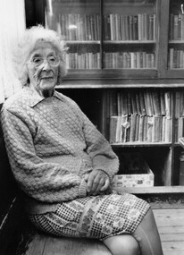 Woman sitting in a library.