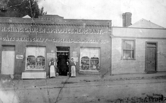 People standing outside a shop.