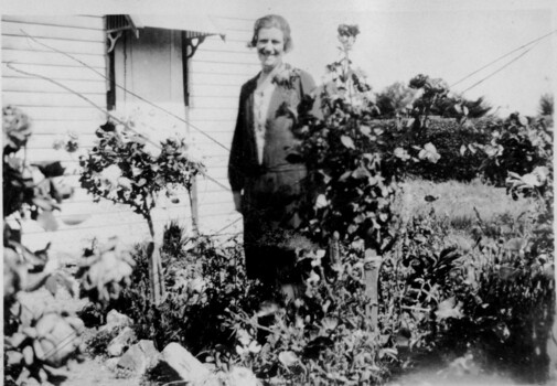 woman standing in a garden.