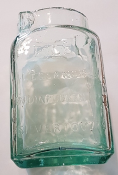 Clear green glass jar.