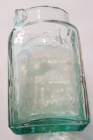 Clear green glass jar.