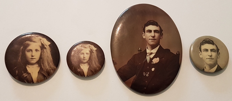 Four brooches with portraits on them.