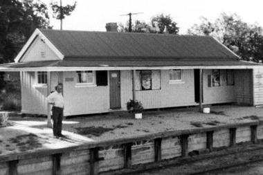 Man standing of a railway platform.