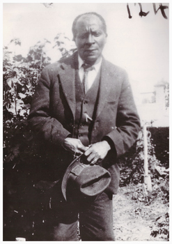 Image of a man holding a hat.