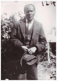Image of a man holding a hat.