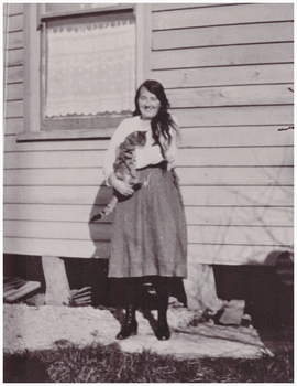 Young woman holding a cat.