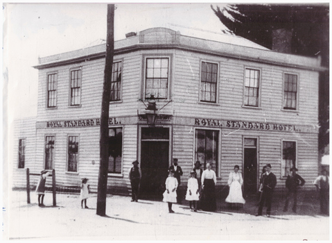 People outside an early hotel.