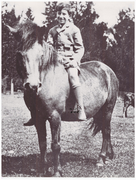 Boy riding a pony.