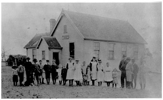 Pupils outside a school building.