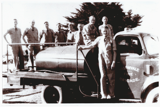 Fire brigade members on a fire tanker.