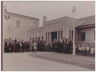 Large group of people outside a building.