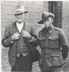 Two men, one in military uniform.