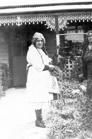 Two women in front of a house.