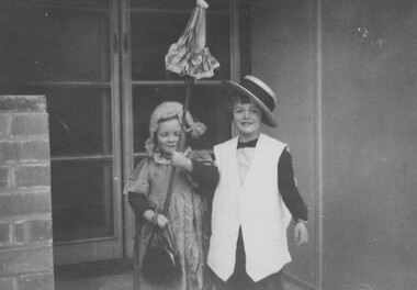 Two young children wearing costumes.