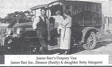 Two adults, and a child standing next to a van.