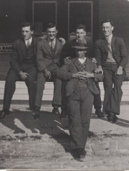 Five men outside a building.