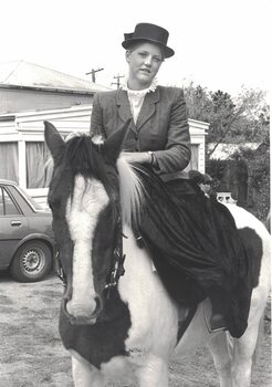 Young girl riding a horse.