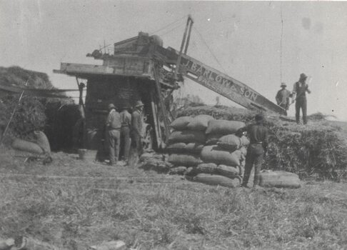 Men and a chaff cutting machine.