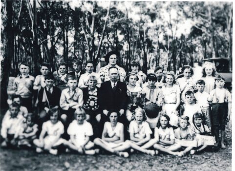 Group of pupils and teachers with trophies.