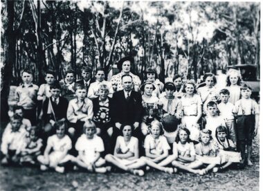 Group of pupils and teachers with trophies.