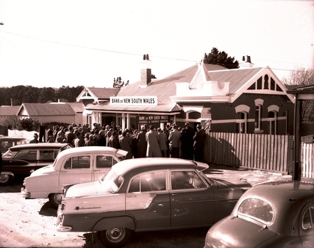 People outside a bank building.