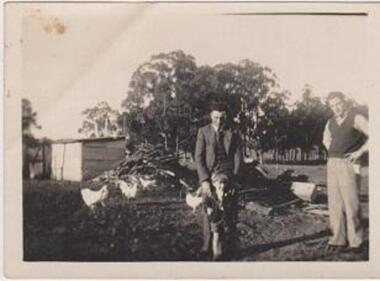 Image of two men and a small child.