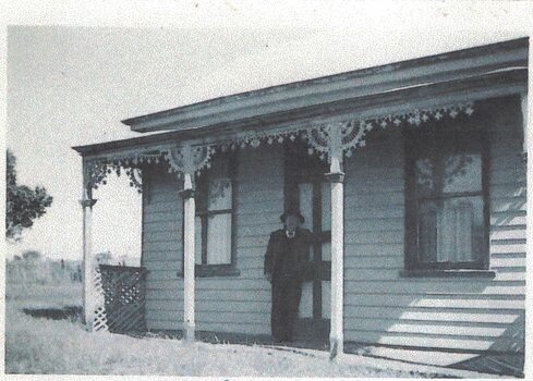 Man at front door of a house.