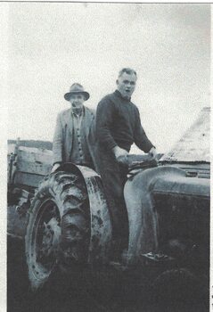 Two men on a tractor.