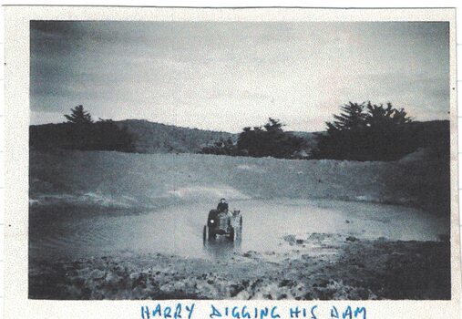 Man on a tractor in a dam.