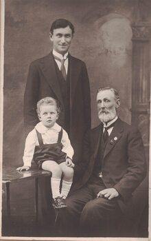 Portrait of two men and a young child.