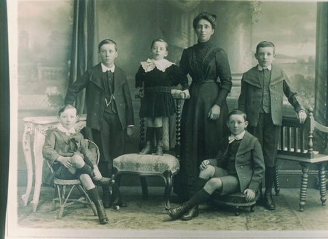 Portrait of a woman with five children.