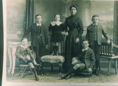 Portrait of a woman with five children.