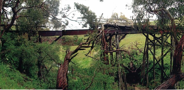 Trestle bridge over a creek after a flood.