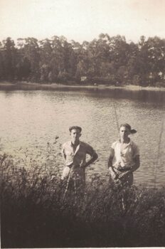 Two men at a lake.